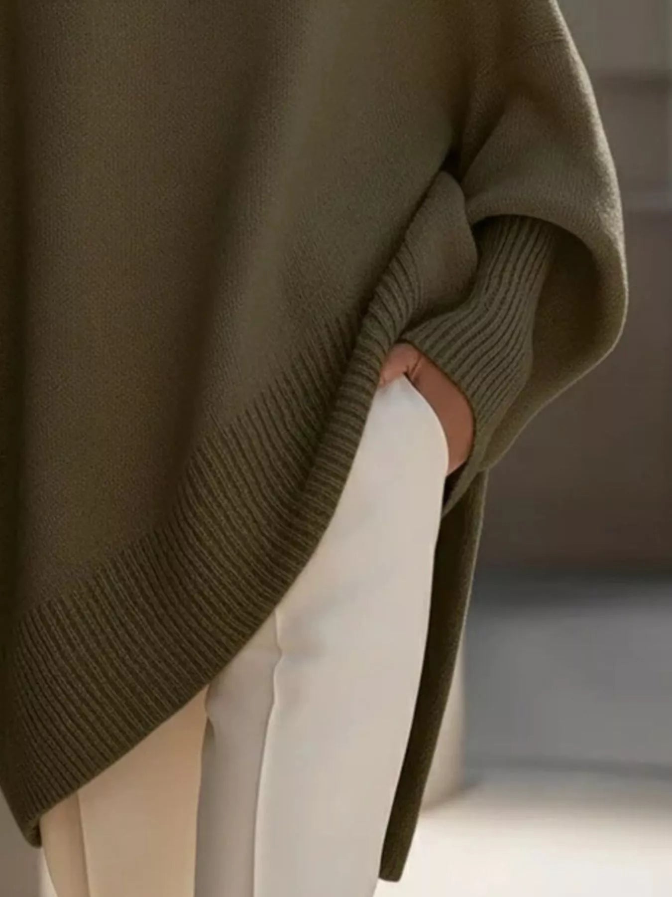 Olive green oversized knit sweater with batwing sleeves and ribbed cuffs