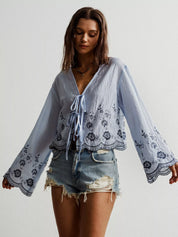 Blue and white floral embroidered tie-front blouse with bell sleeves