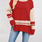 Red and cream color-blocked knit sweater with side slits and ribbed details