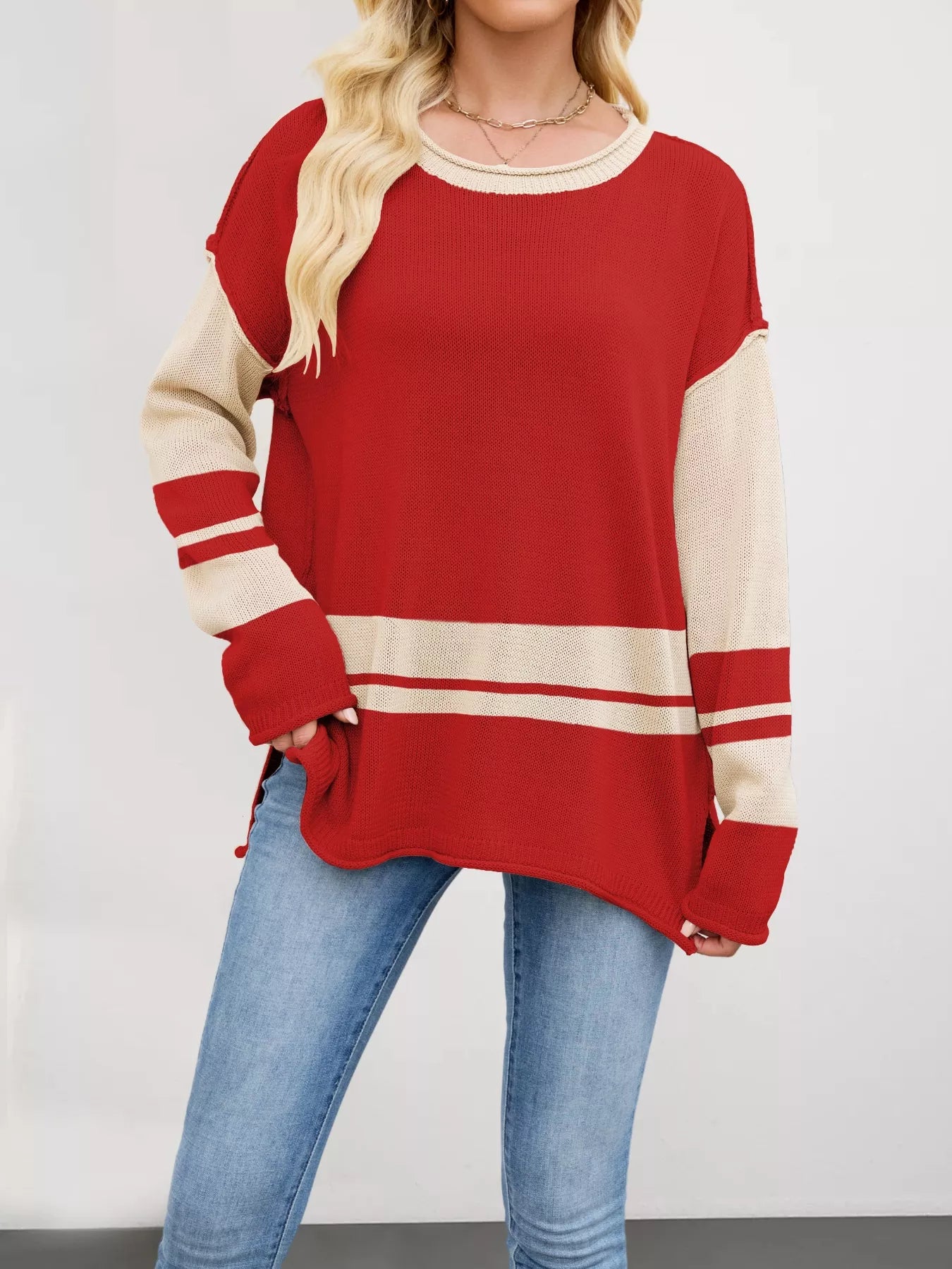 Red and cream color-blocked knit sweater with side slits and ribbed details