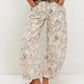 Printed wide-leg jeans with muted beige gray floral pattern