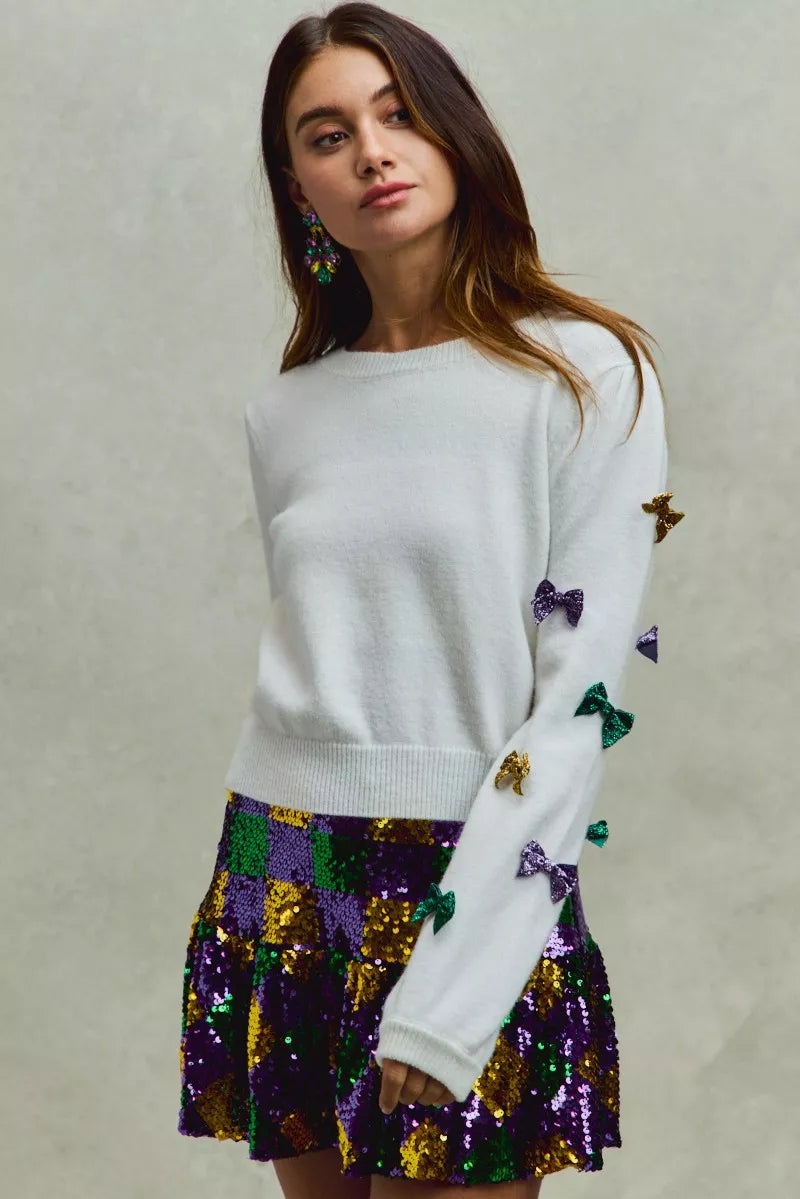 White SO ME Mardi Gras glitter bow sweater with sequined stars on sleeves