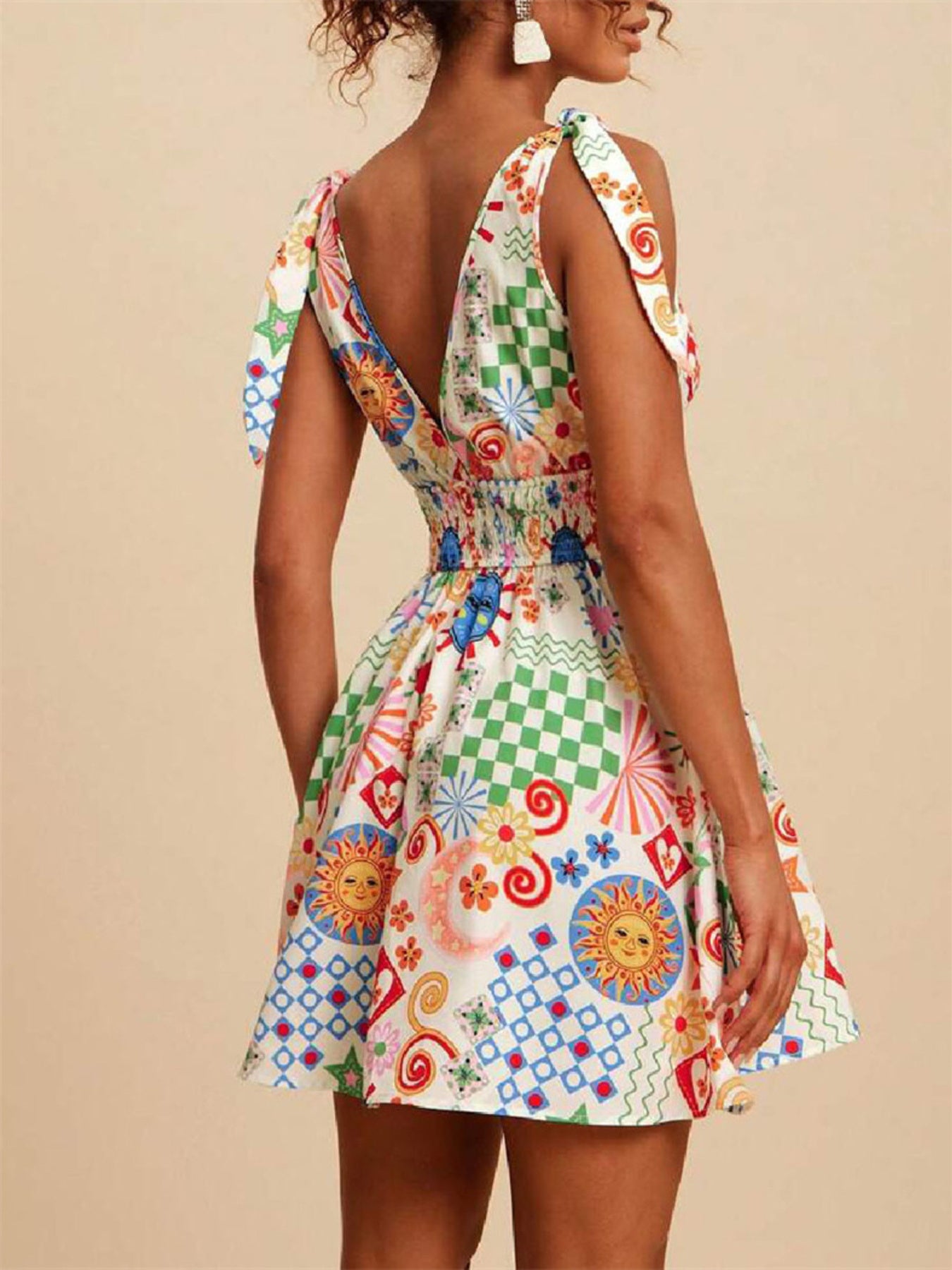 Daverri V-neck smocked waist mini dress with vibrant sun, checker, swirl print