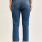 Judy Blue mid-rise boyfriend jeans with embroidered repair patches, blue denim, five-pocket design, and rolled cuffs