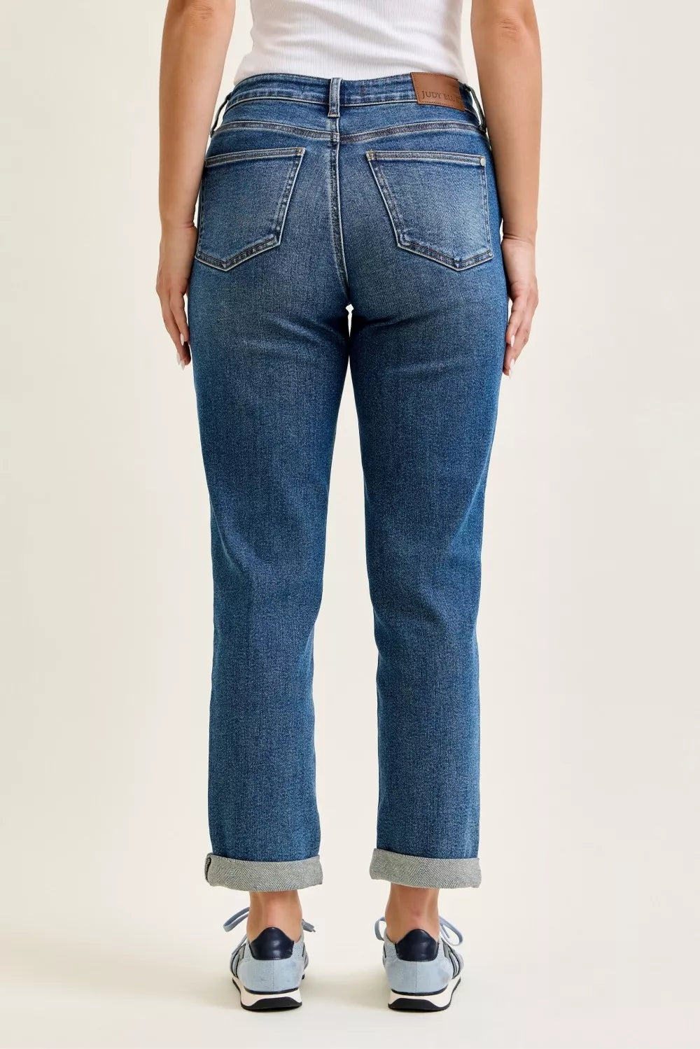 Judy Blue mid-rise boyfriend jeans with embroidered repair patches, blue denim, five-pocket design, and rolled cuffs