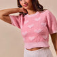 Pink fuzzy cropped sweater with SO ME heart knit details