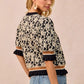 BiBi Textured Rose Knit Top with black cream floral print and ruffled cuffs