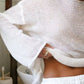 Boat neck dropped shoulder sweater in soft off-white knit with bell sleeves
