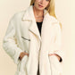 Cream-colored Davi & Dani faux fur bomber jacket with black zipper and belt