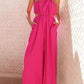 Vibrant fuchsia cutout sleeveless wide-leg halter jumpsuit