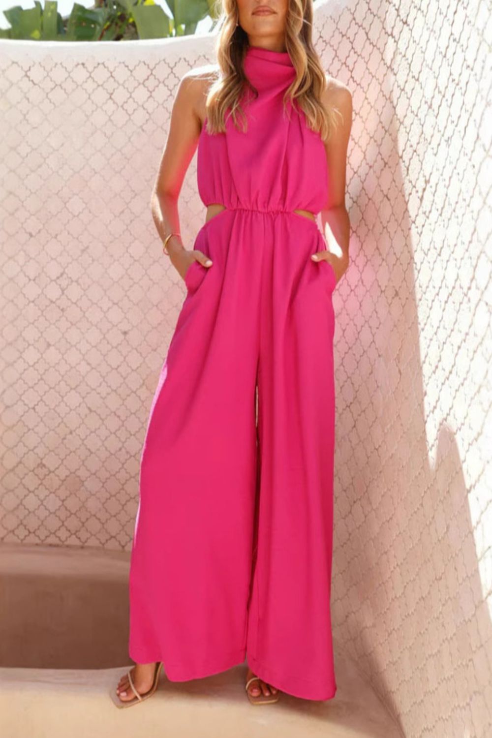 Vibrant fuchsia cutout sleeveless wide-leg halter jumpsuit