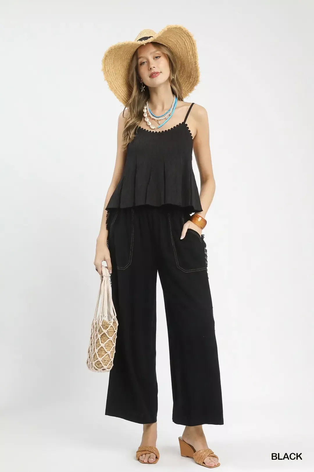 Black ruffled sleeveless Umgee top with scalloped edges and thin straps
