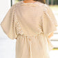 Woman in beige and brown striped V-neck puff sleeve blouse