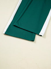 Green round neck top and drawstring pants set in folded green fabric with white trim