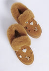 Tan faux fur-lined slip-on moccasins with heart and star charms