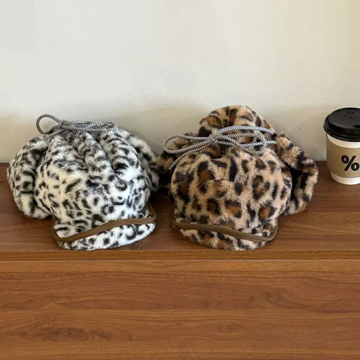 Two leopard print faux fur bucket bags in black/white and tan/brown
