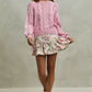 Soft pink cable-knit sweater with SO ME floral print skirt