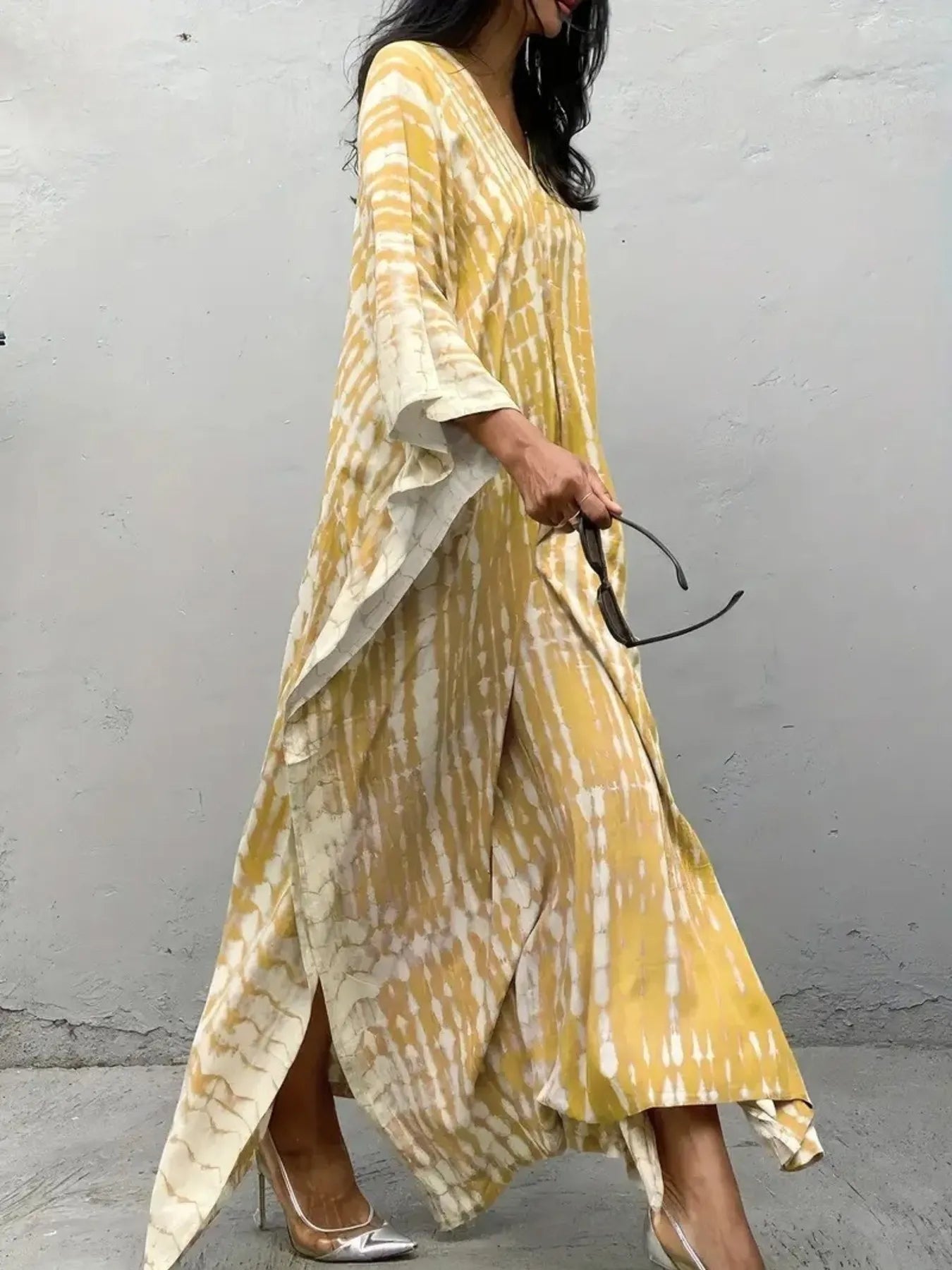 Flowing yellow and cream tie-dye V-neck maxi dress with bell sleeves and side slits