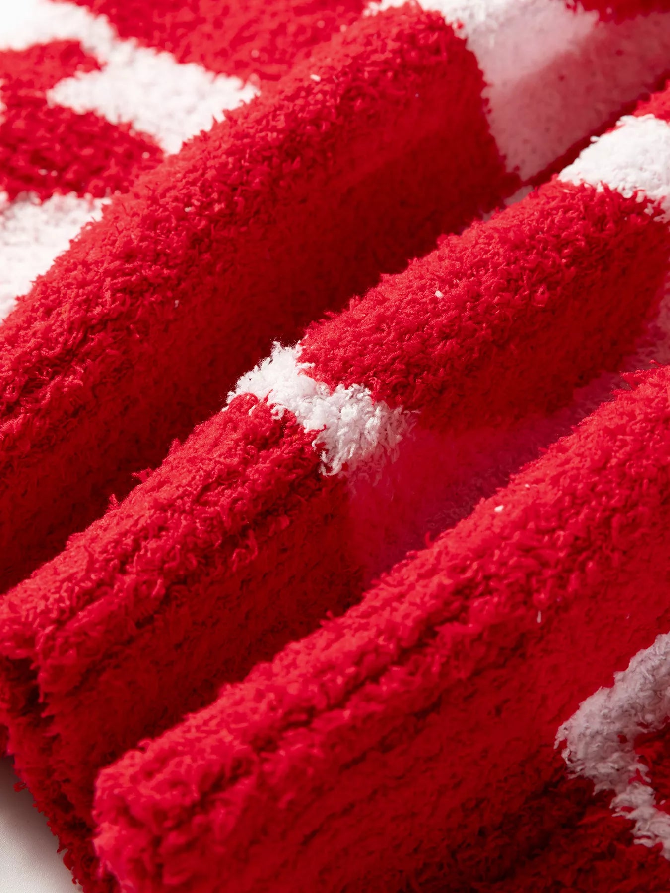 Red and white striped plush towel with soft textured surface for Daverri sweater