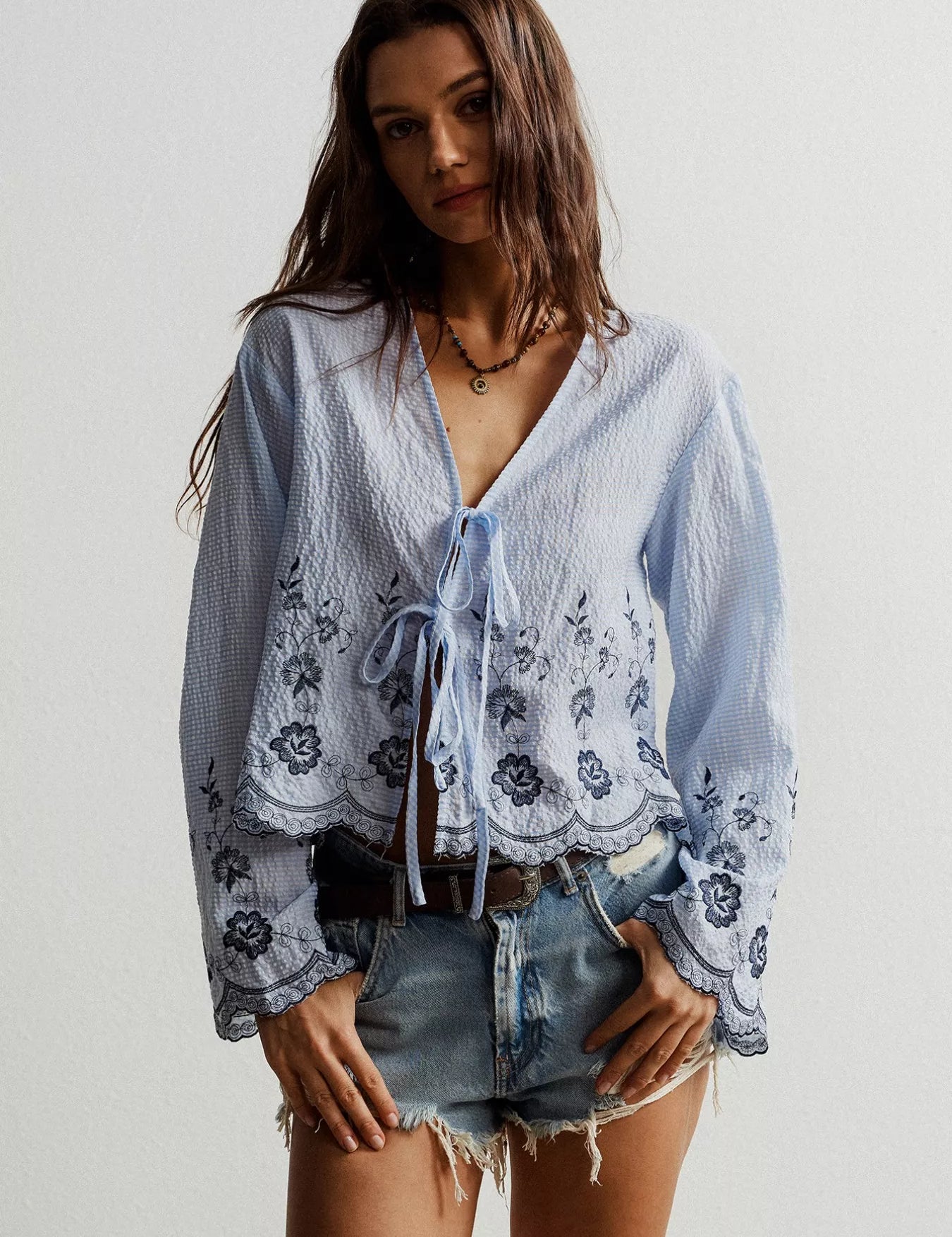Blue and white floral embroidered Free People tie-front blouse with lace trim