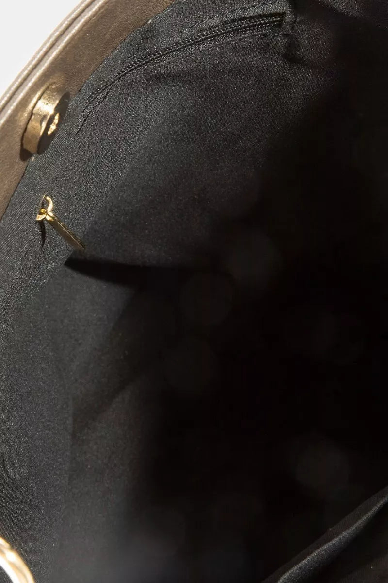 Black interior lining with gold-tone hardware in Fame Studded Leather Bucket Bag