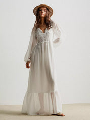 Boho chic white lace maxi dress with bell sleeves and straw hat