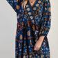 Bohemian floral print long sleeve mini dress in navy blue with orange, white, and light blue patterns