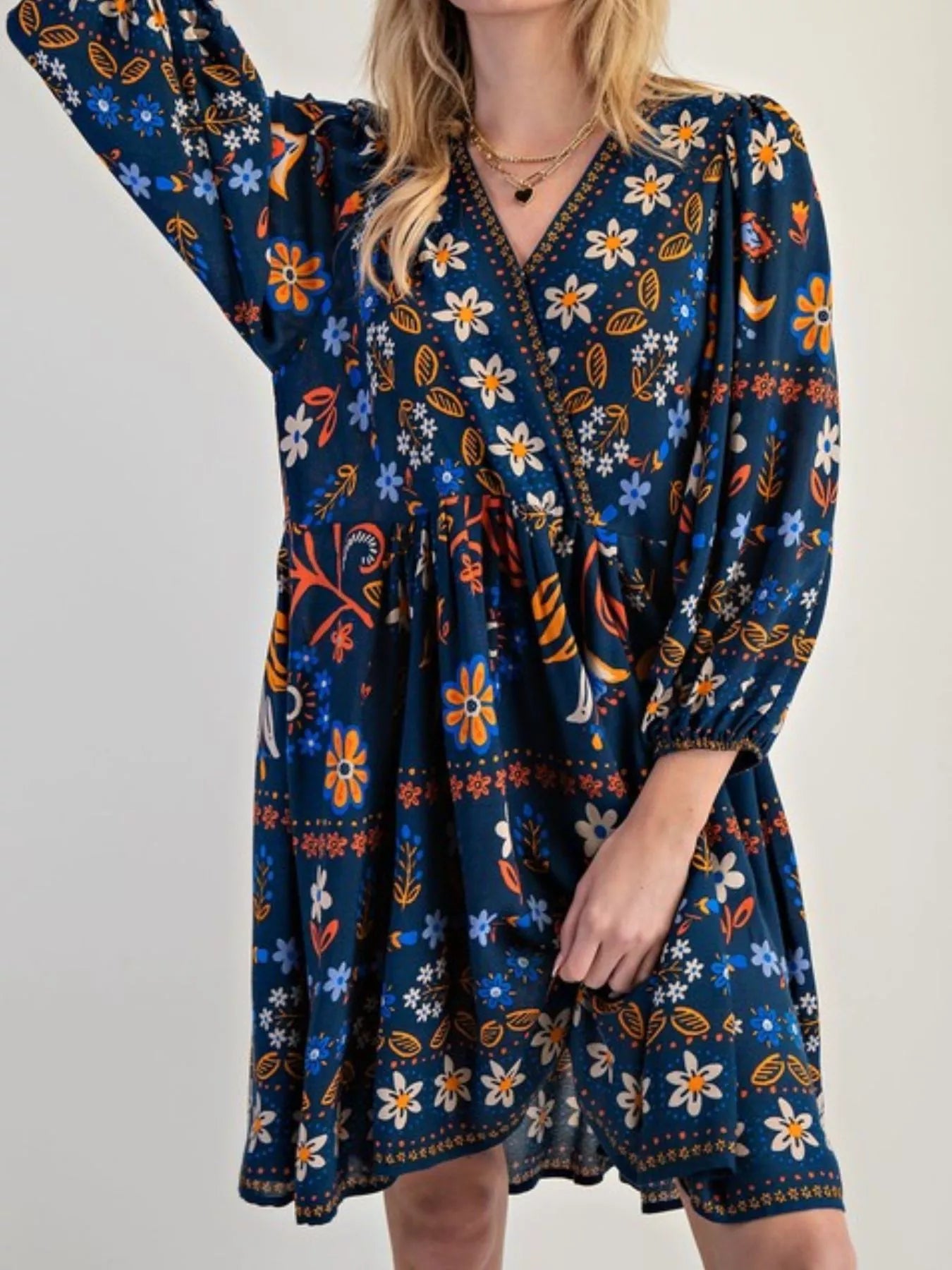 Bohemian floral print long sleeve mini dress in navy blue with orange, white, and light blue patterns