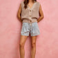 Beige knitted sleeveless cardigan on SO ME mid-rise denim shorts