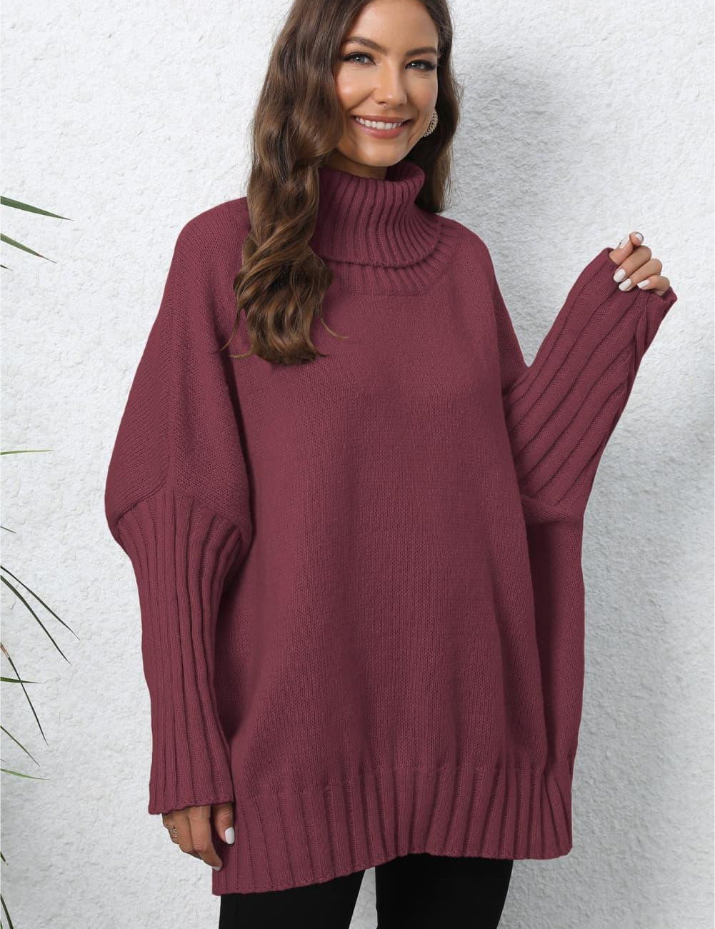 Oversized maroon turtleneck sweater with cable knit sleeve details