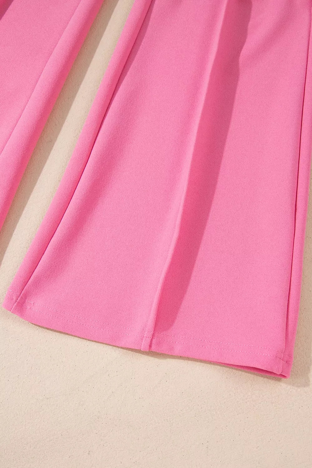 High-waisted bootcut pants in bright pink soft fabric with smooth texture