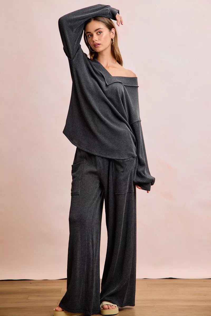 Dark gray ribbed off-shoulder V-neck top with long sleeves, relaxed fit