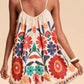 Floral print spaghetti strap romper in vibrant off-white with embroidered blossoms