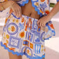 Bohemian print shorts in white blue orange with scalloped hem