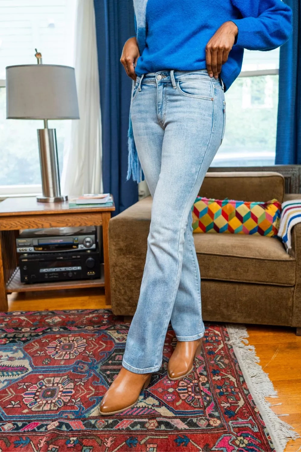 Judy Blue mid-rise thermal bootcut jeans in light blue denim with relaxed fit and brown leather boots