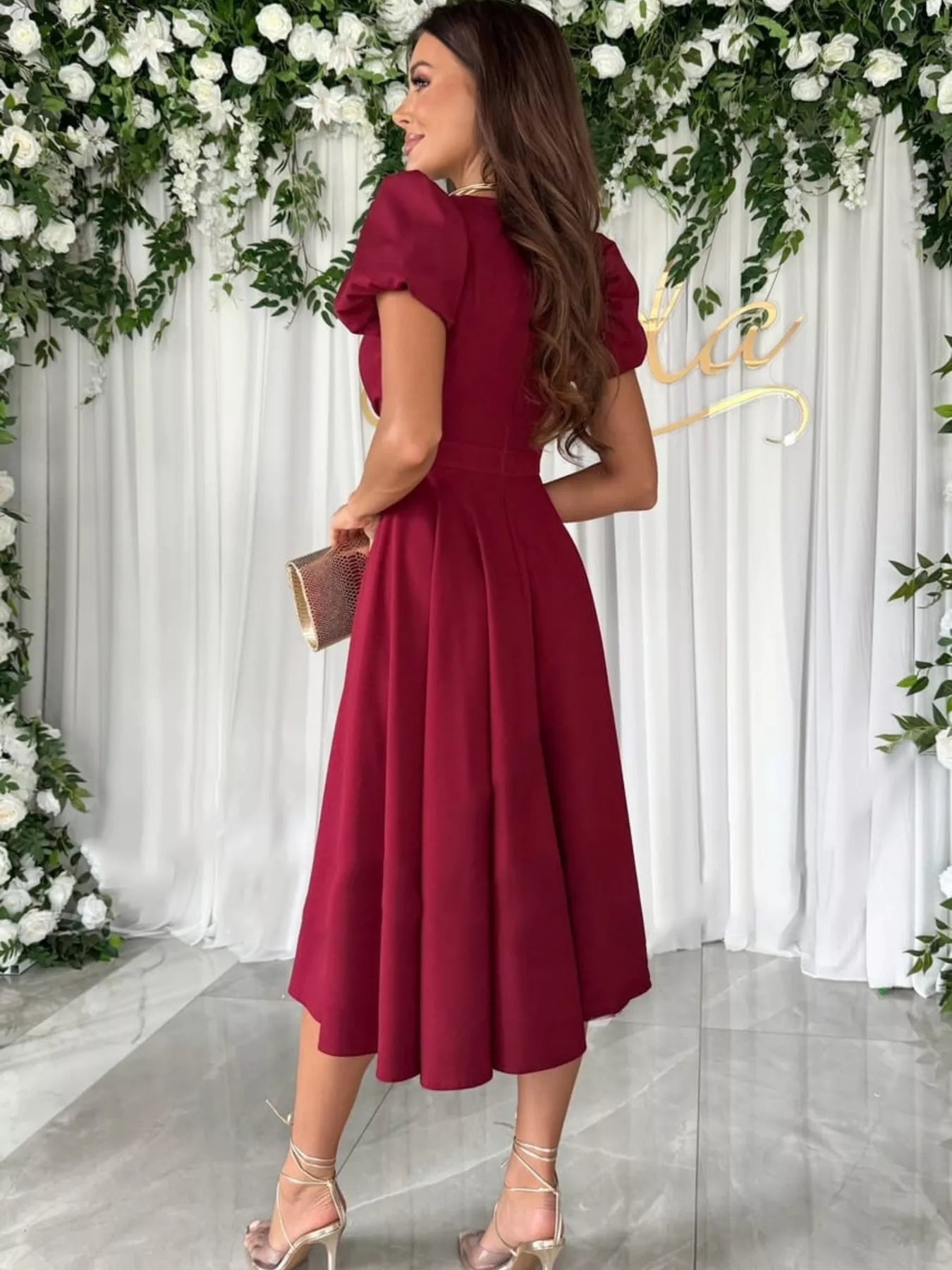 Woman in burgundy Surplice Short Sleeve Midi Dress with puffed sleeves