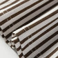 Brown and white striped elastic high waist pocketed loose pants fabric close-up