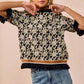 BiBi Textured Rose Knit Top in black and cream floral print with ruffled sleeves