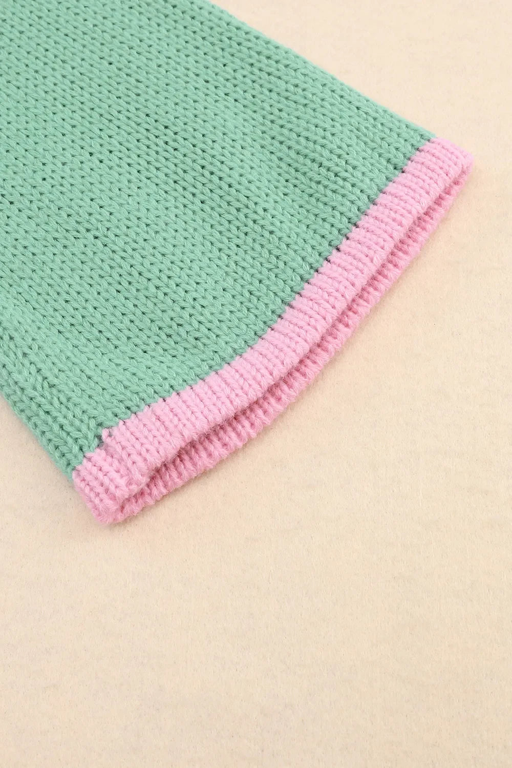 Mint green and pink knitted baby blanket with textured pattern
