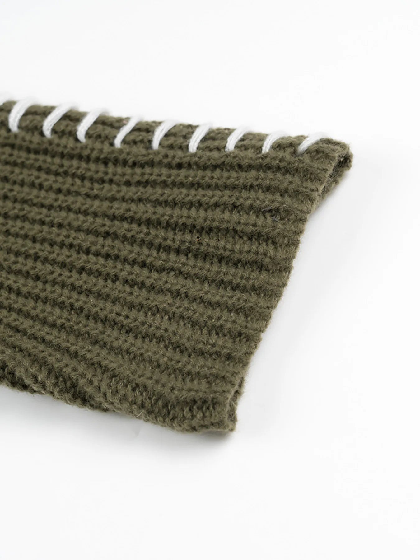 Olive green textured knit scarf with white cord accents on sweater