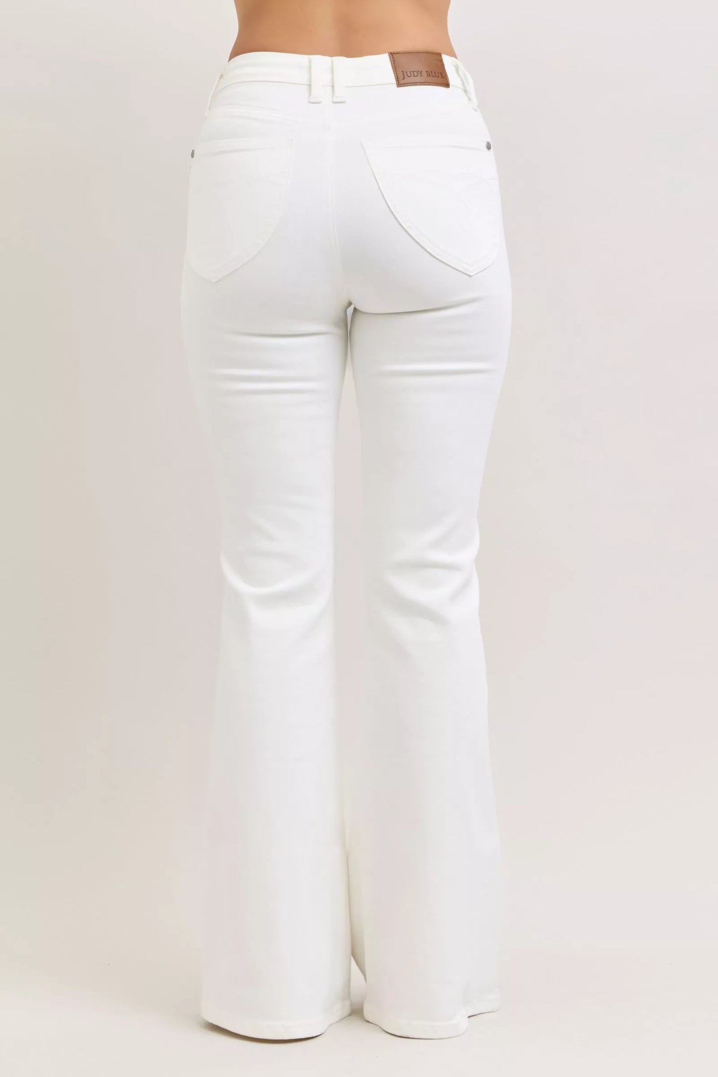 White Judy Blue high-waisted flared jeans with brown leather patch