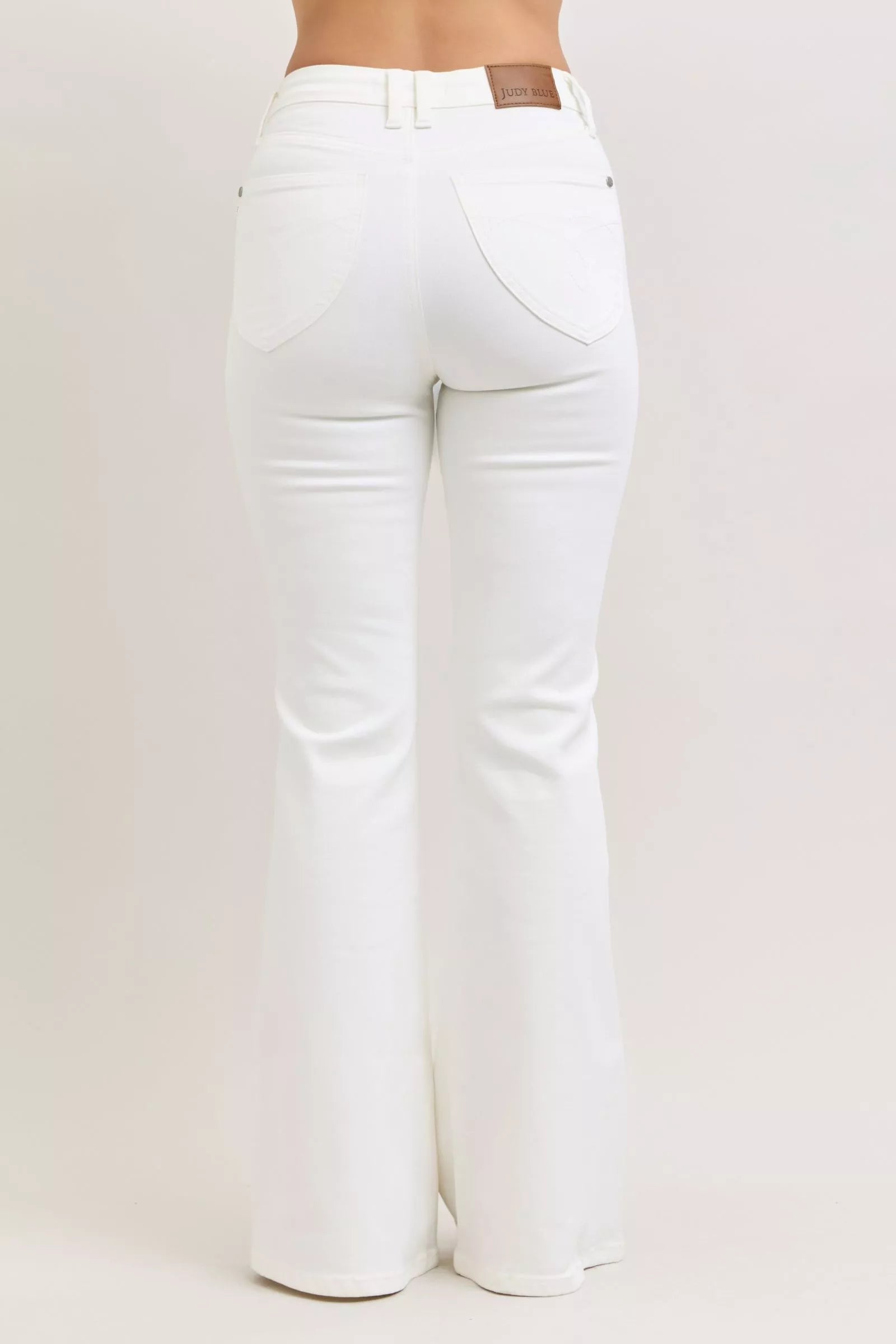 White Judy Blue high-waisted flared jeans with brown leather patch