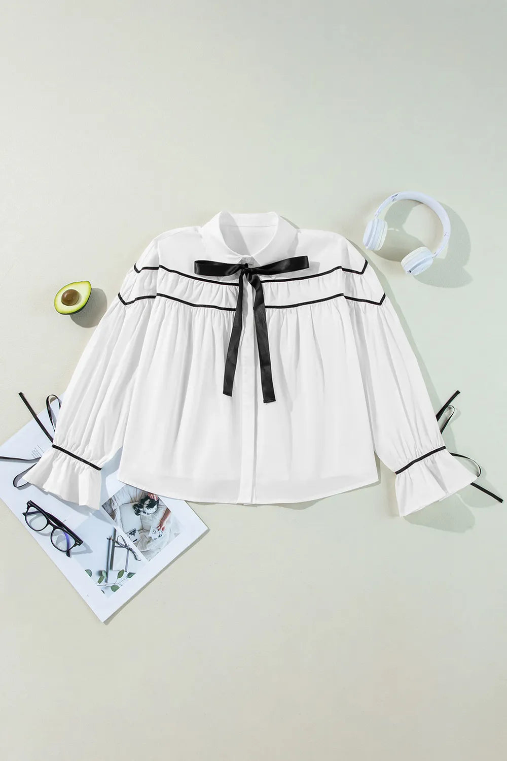 White ribbon bowtie collared blouse with black trim and flounce sleeves