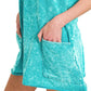 Teal acid-washed cotton mini dress with mottled texture, pockets and romper liner