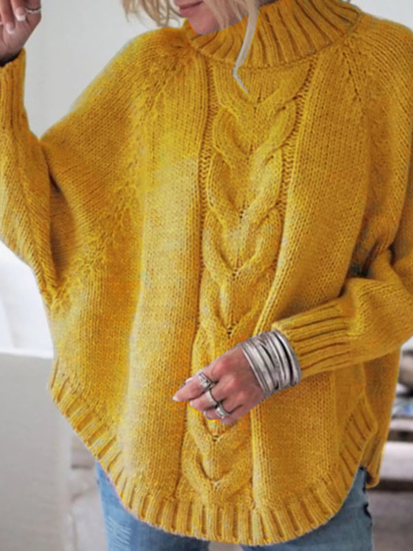 Cozy mustard-yellow cable-knit turtleneck sweater with wide sleeves