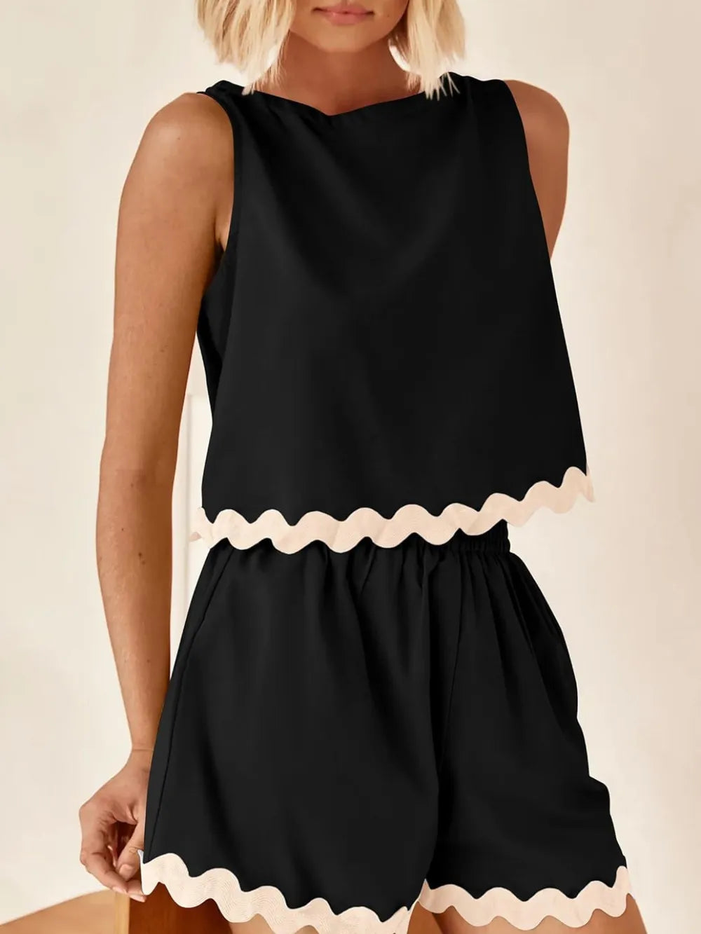 Daverri Fashions black sleeveless top with cream scalloped hem