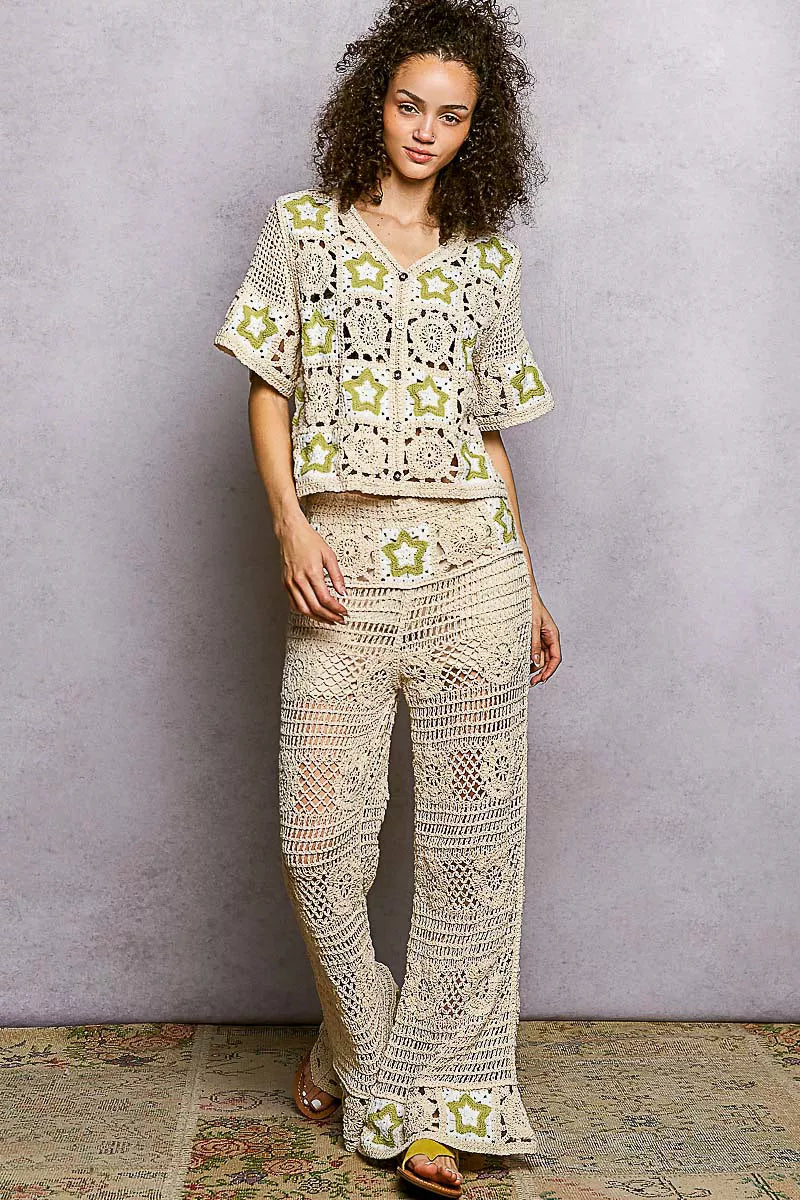 Woman in POL openwork crochet flare pants with cream sage geometric patterns