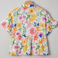 Floral boxy fit ruffled short sleeve blouse with vibrant peplum hem