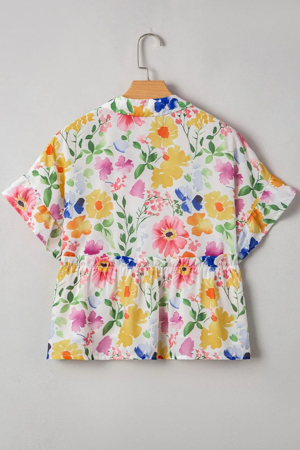 Floral boxy fit ruffled short sleeve blouse with vibrant peplum hem
