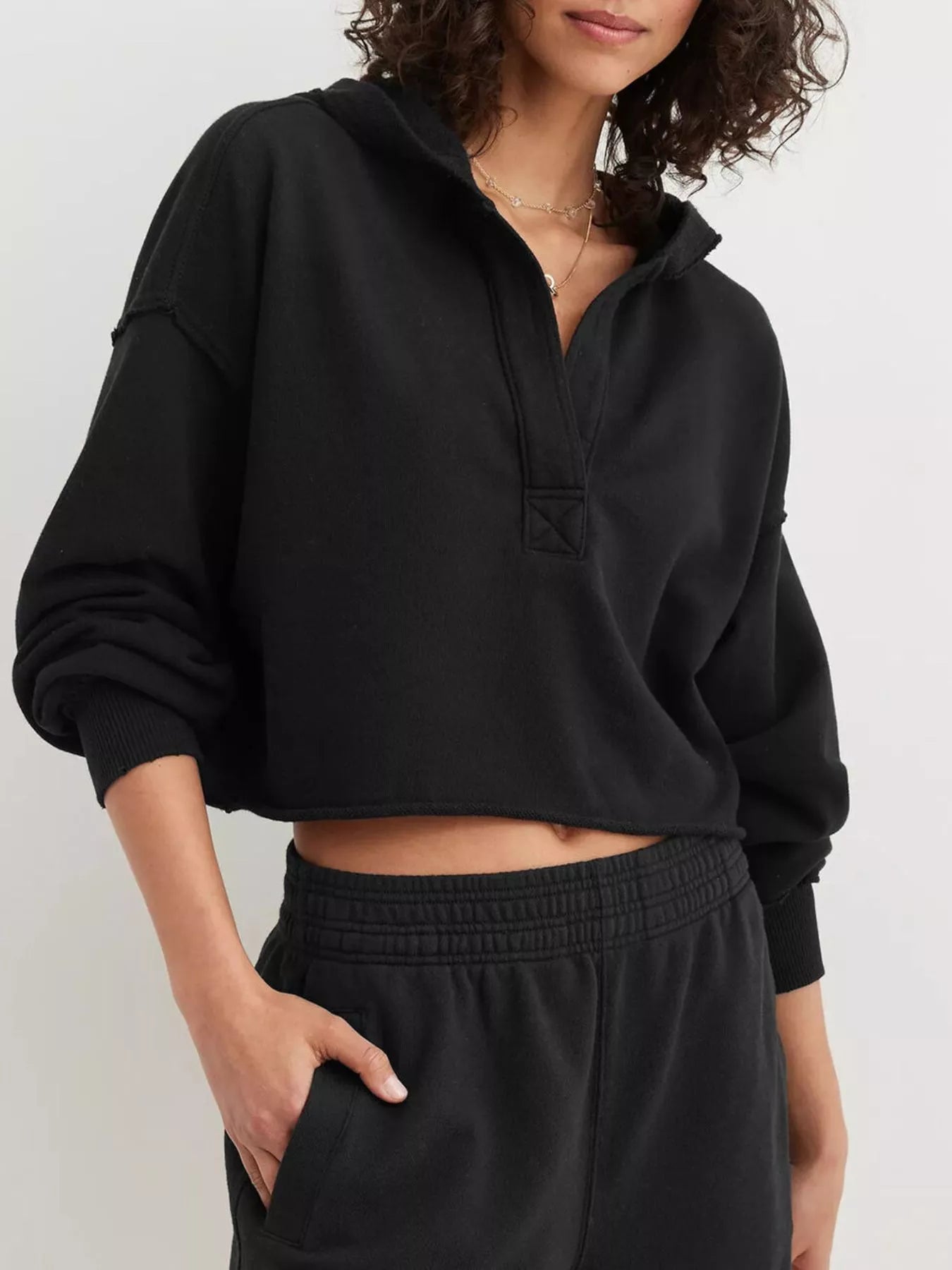 Black Exposed Seam Dropped Shoulder Hoodie with oversized fit and ribbed cuffs